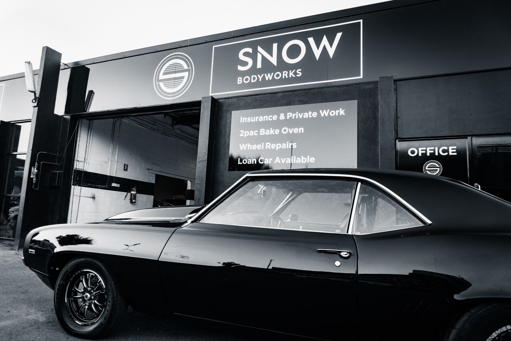 Modern Black Car Outside Workshop — Panel Beaters in Southport, QLD