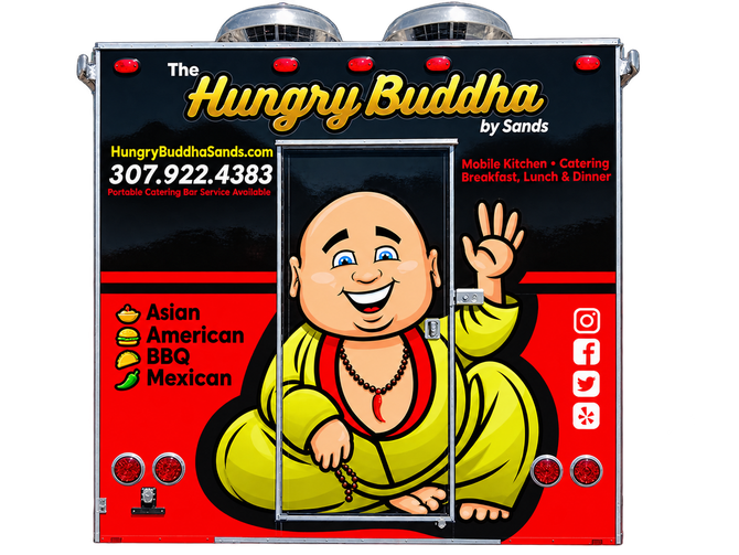 Food truck named “Hungry Buddha” with a smiling cartoon Buddha on the side, parked in a lot.