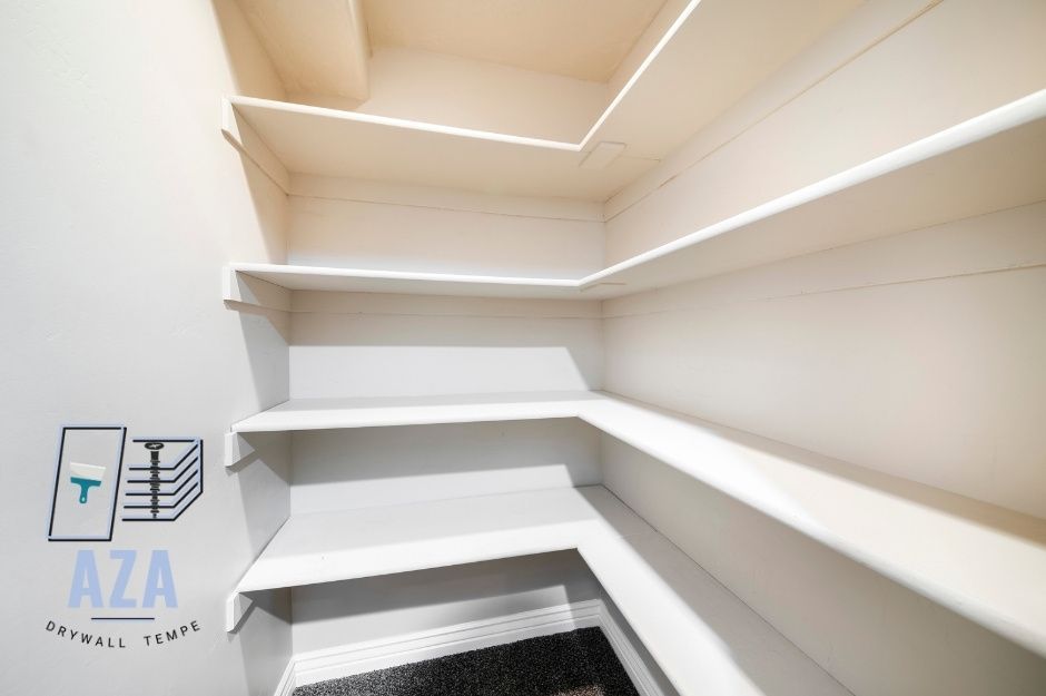Newly installed closet sheetrock with shelves for organizing clothes and accessories.