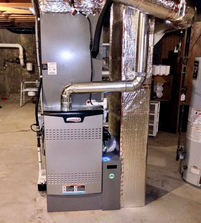 Lennox furnace in basement, with metal ductwork and water heater nearby.