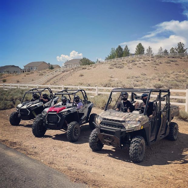 side front view of grey Polaris RZR 1000 with blue highlights