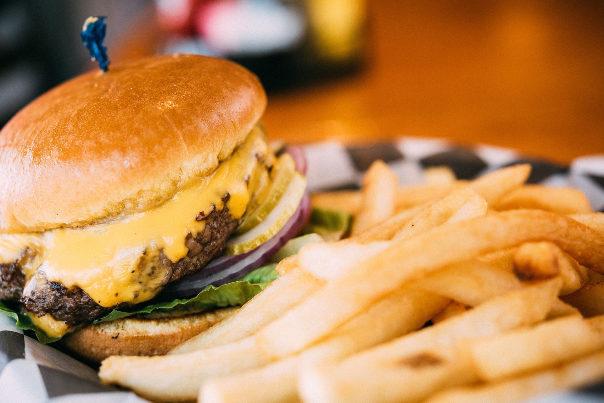 A close up of a hamburger and french fries on a plate.