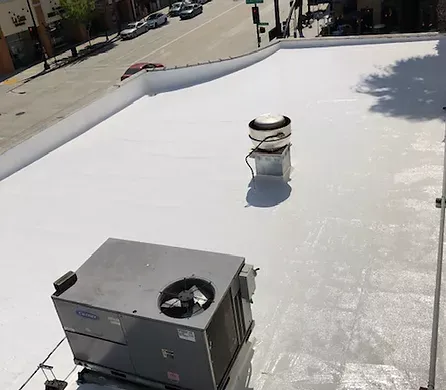 An air conditioner is sitting on top of a new white roof that was built by Four Peaks Roofing in Fort Myers