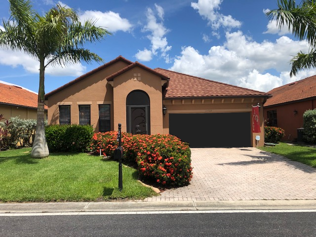 An aerial view of a house with a tiled roof installed by Four Peaks Roofing in Estero