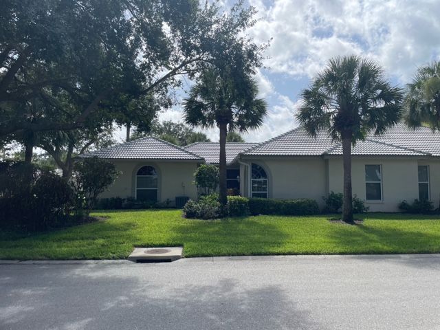 An aerial view of a residential home with a brand new roof installed by Four Peaks Roofing in Naples