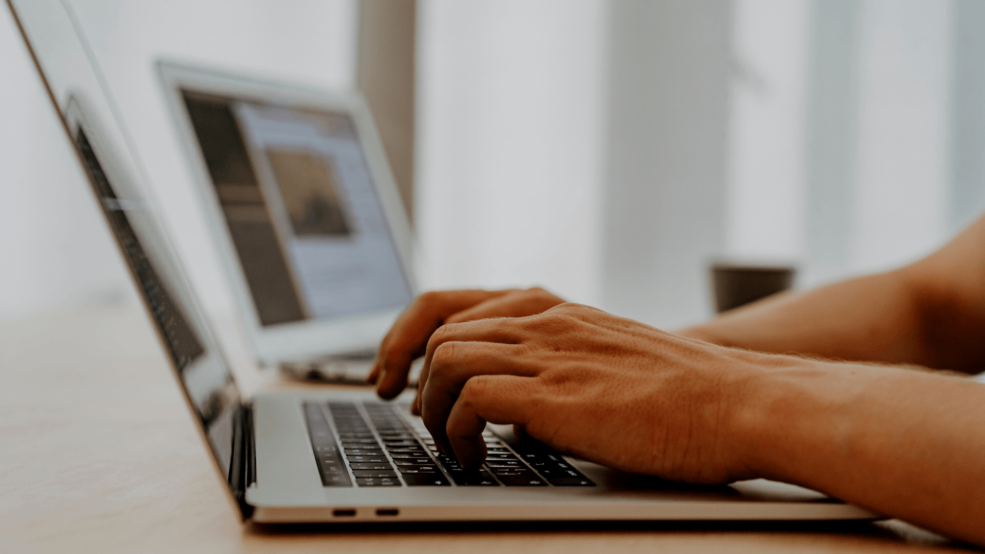 A person is typing on a laptop computer.