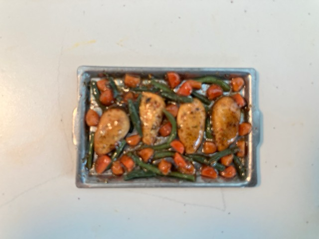 Three small bowls of green salad with vegetables on a white surface