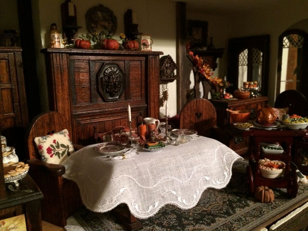 Cozy antique dining room with lace-covered table, carved wood furniture, and decorative objects