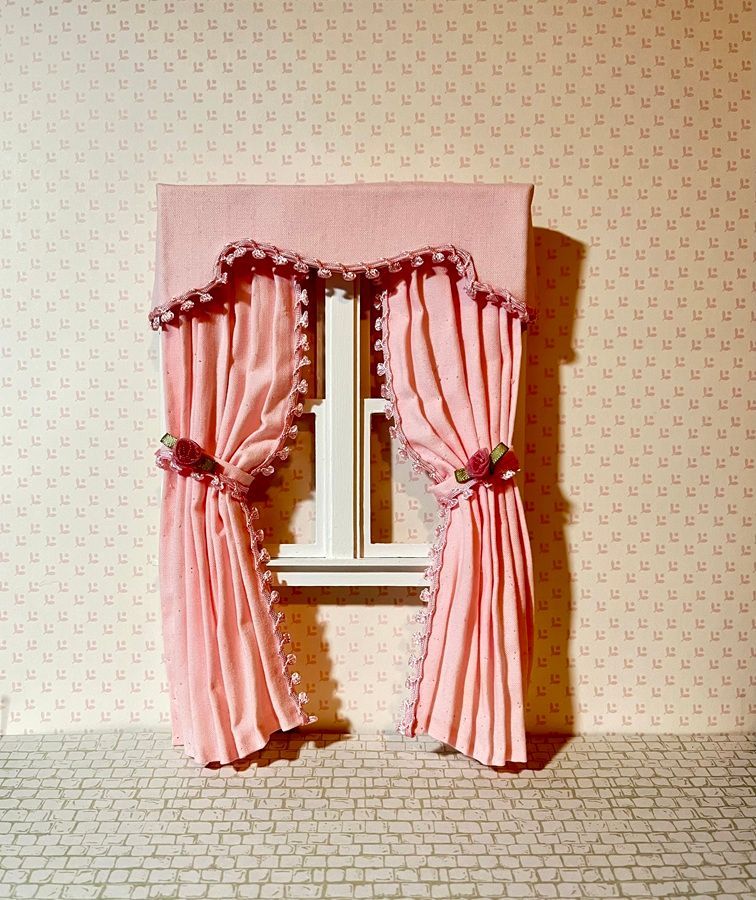 Pink striped curtains framing a small window in a wallpapered room with a patterned floor.