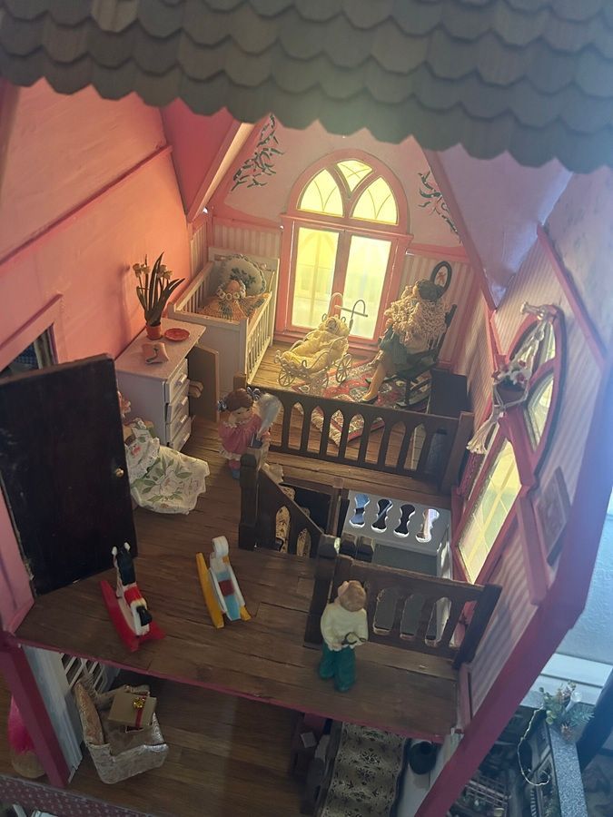 Miniature Victorian dollhouse scenes with figures, horses, and a small storefront interior