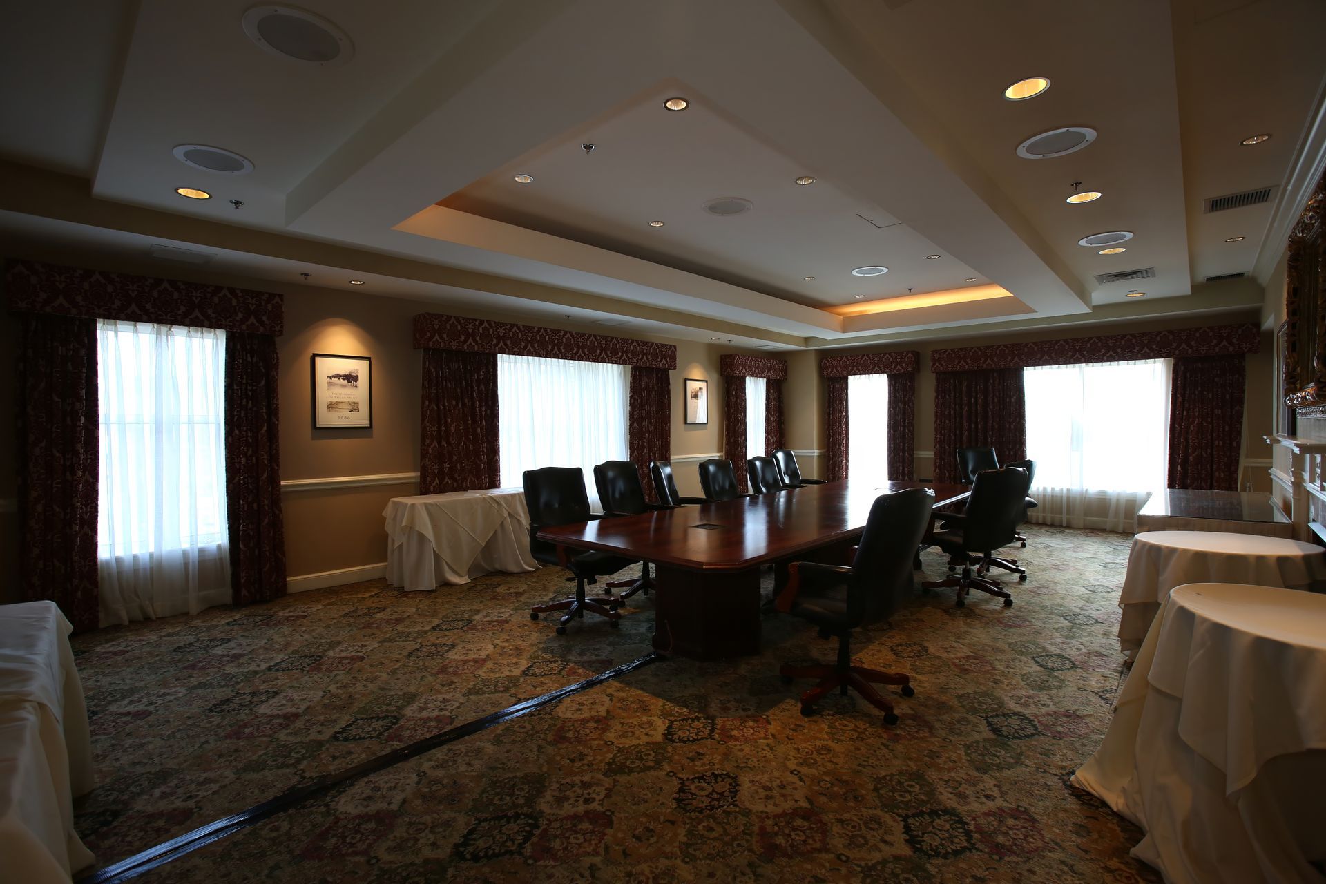 An empty conference room with a long table and chairs