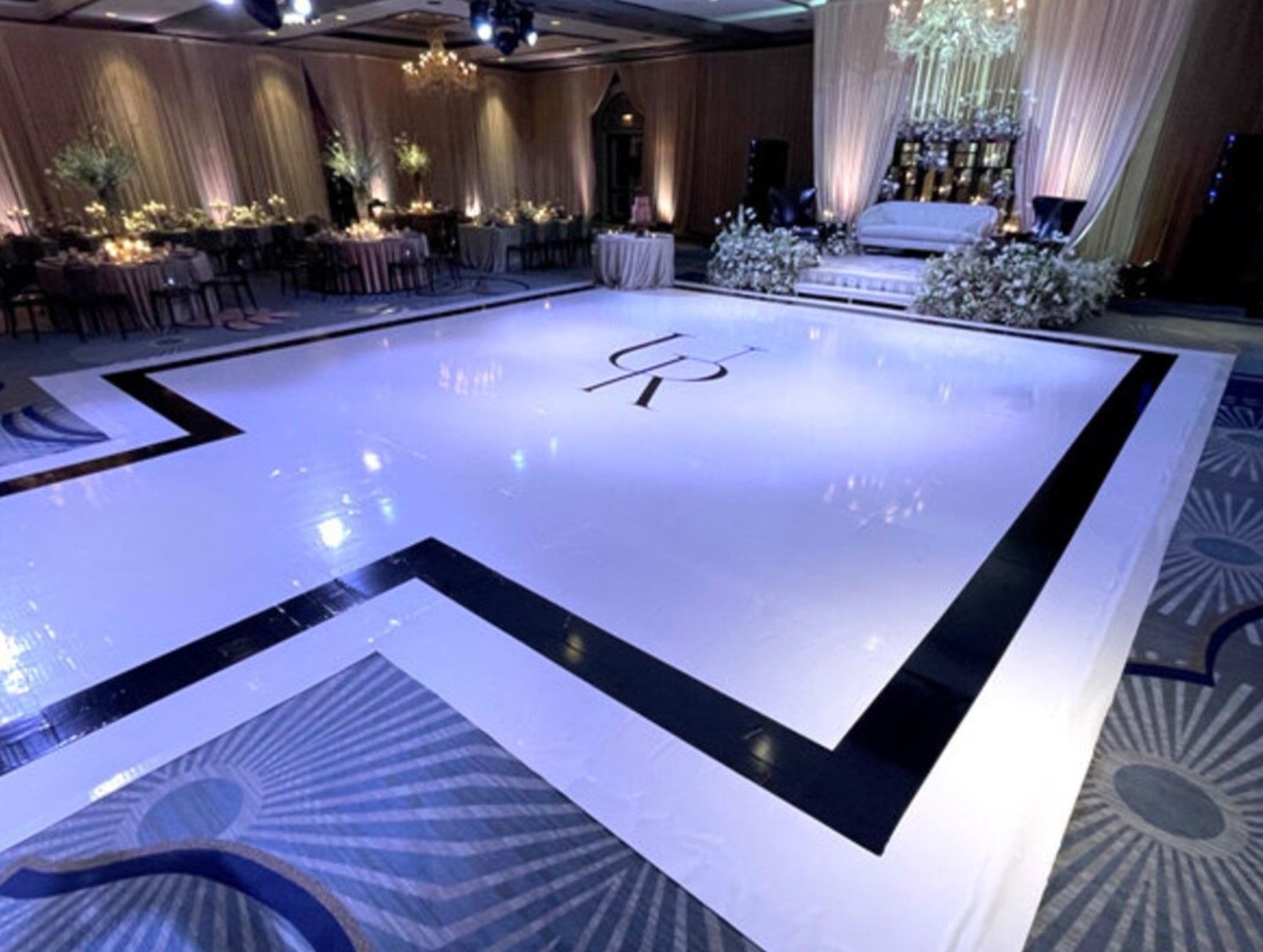 A group of people are dancing on a dance floor at a party.