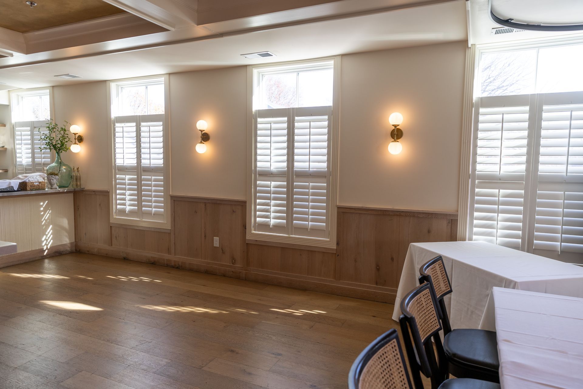 Harvard Boat Club empty room with round tables in the middle and pictures on wall
