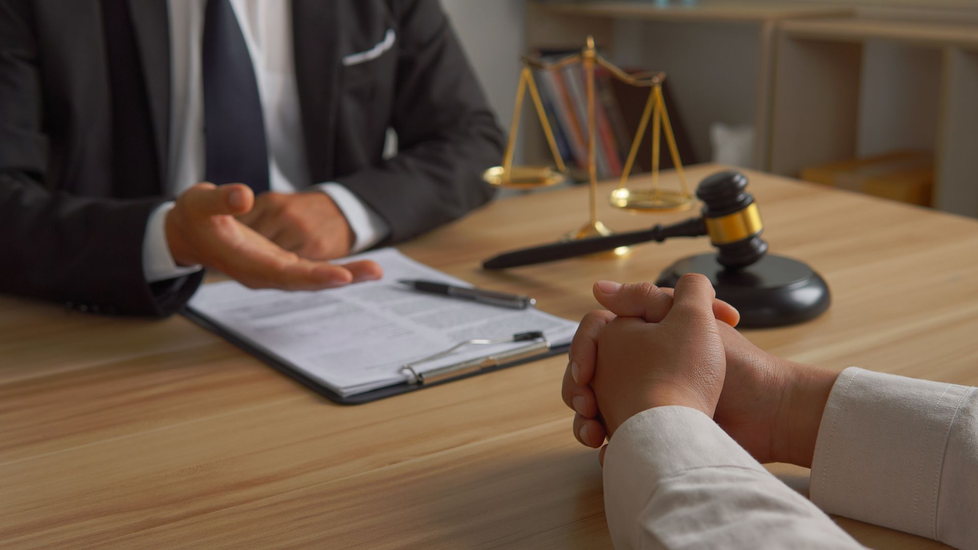 A lawyer is sitting at a table talking to a client.