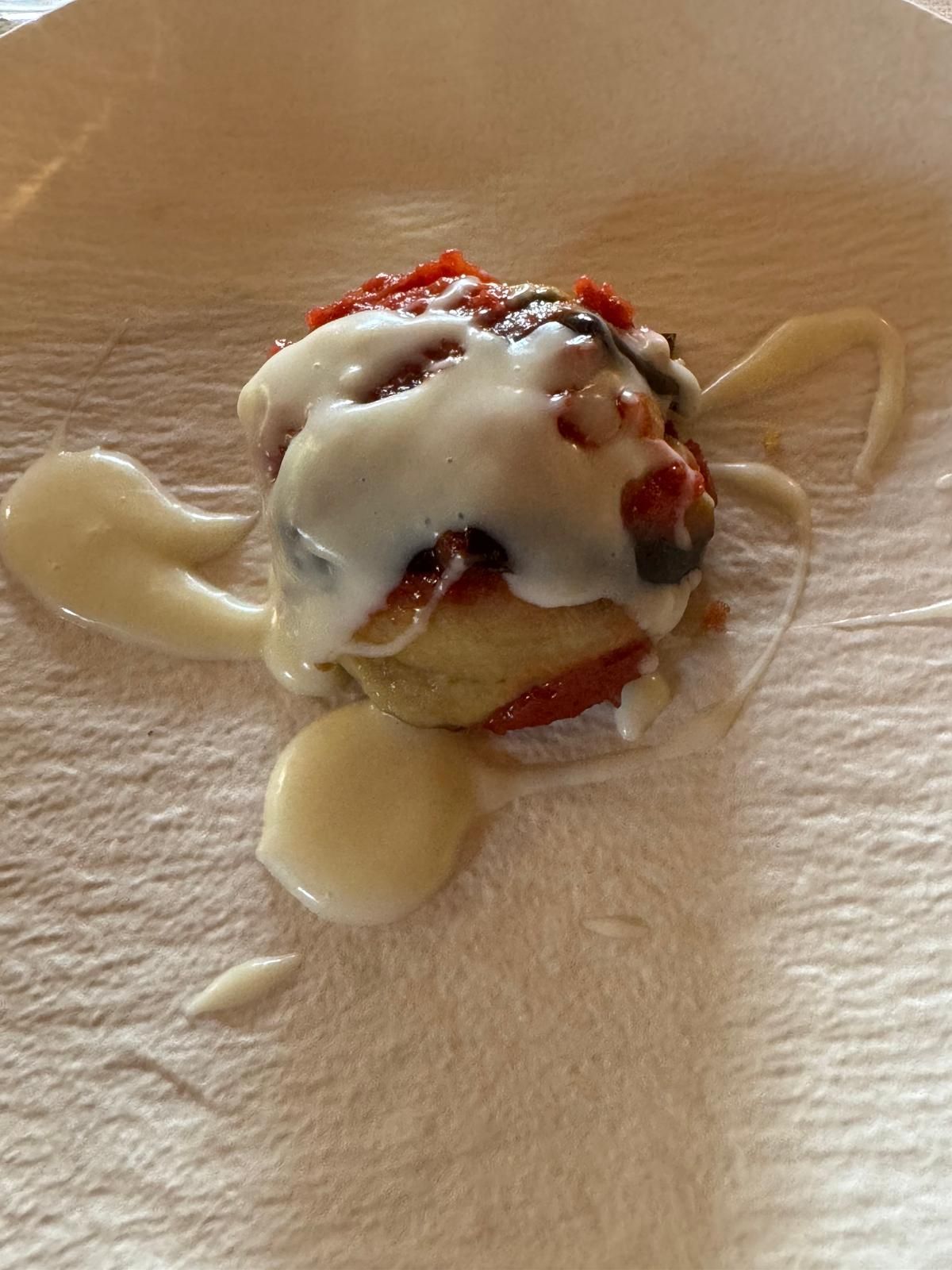 Dessert cremoso con guarnizione rossa rovesciato su un tavolo di legno.