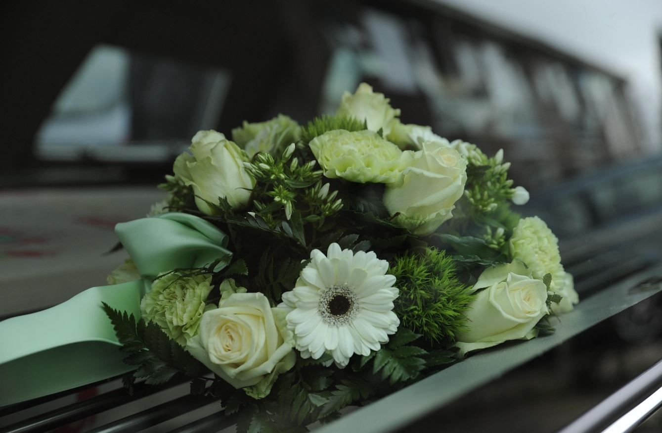 white funeral flowers for burial service in Riverside, IL