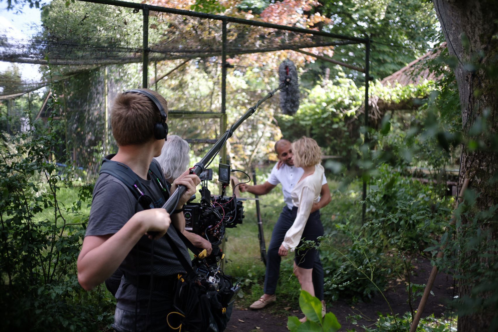 Behind-the-scenes photos of July Janssen on movie sets. Features images with crew members, equipment, director, gaffer, best boy, and DOP