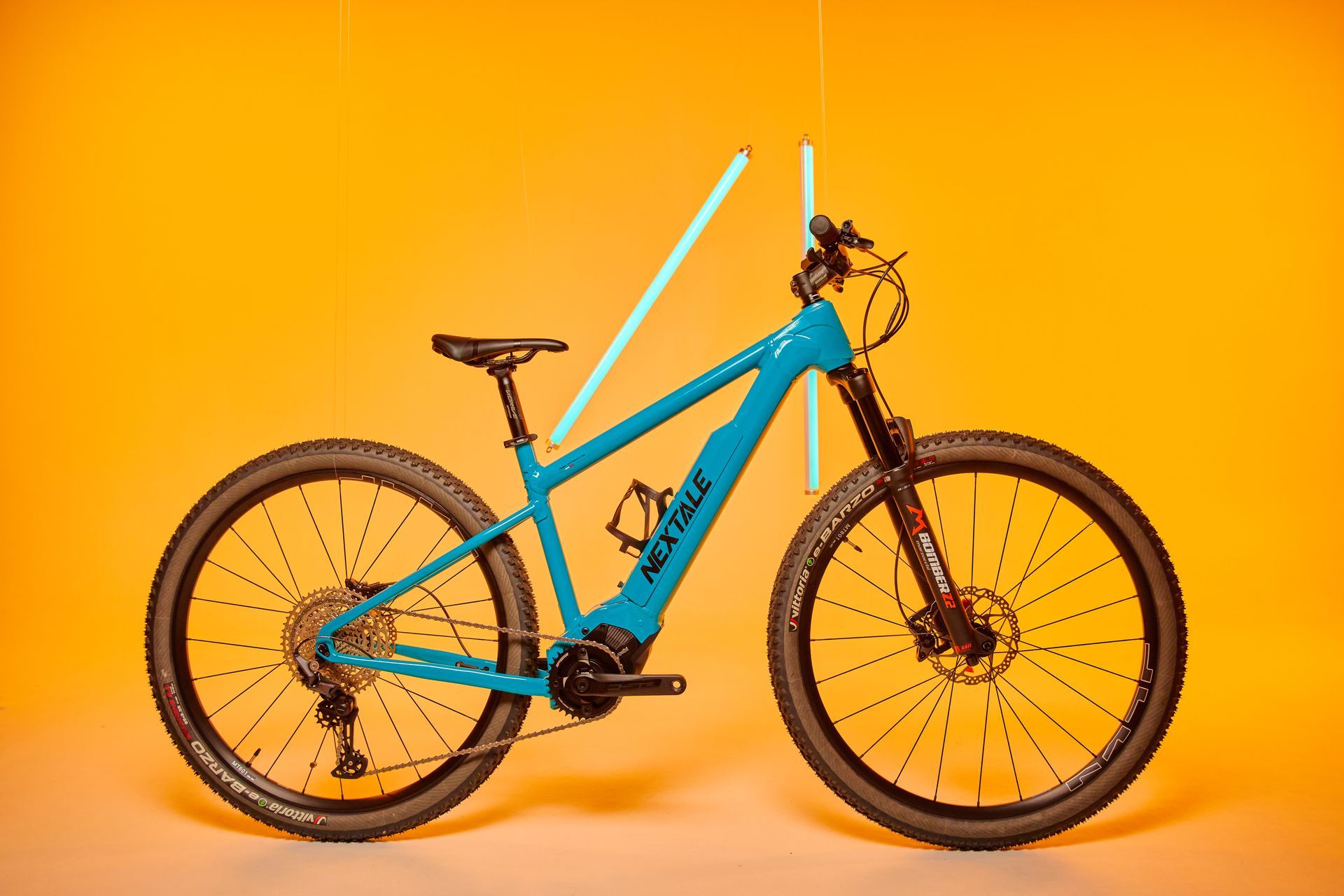 Blue electric mountain bike on a yellow background.