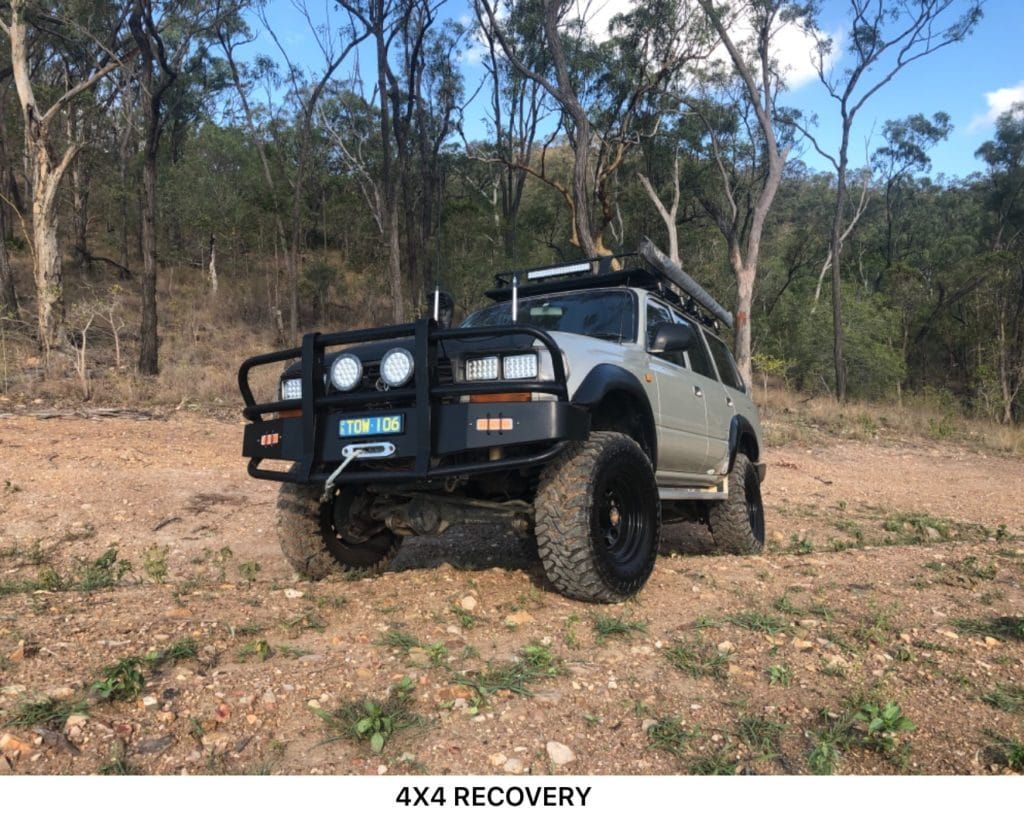 Off-road Vehicle With Black Wheels and a Bull Bar on a Dirt Road — Fitzroy Towing & Transport in Parkhurst, QLD