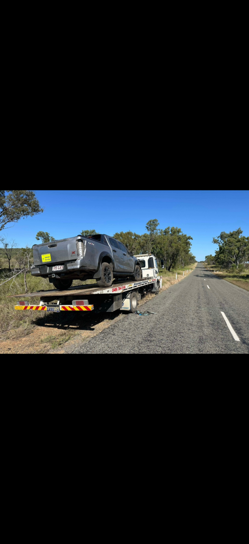 A truck with a camper on it being towed on a road.— Fitzroy Towing & Transport in Parkhurst, QLD