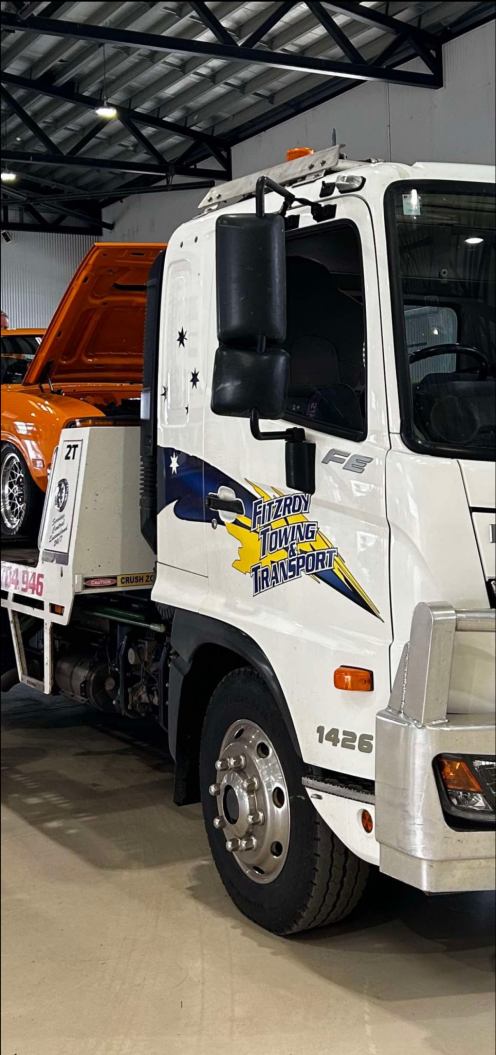 Yellow Machinery on a Flatbed Truck at Warner St Intersection — Fitzroy Towing & Transport in Parkhurst, QLD