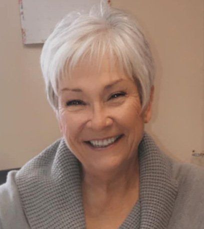 A picture of Commissioner Judy Kveton with white hair and wearing a grey sweater.