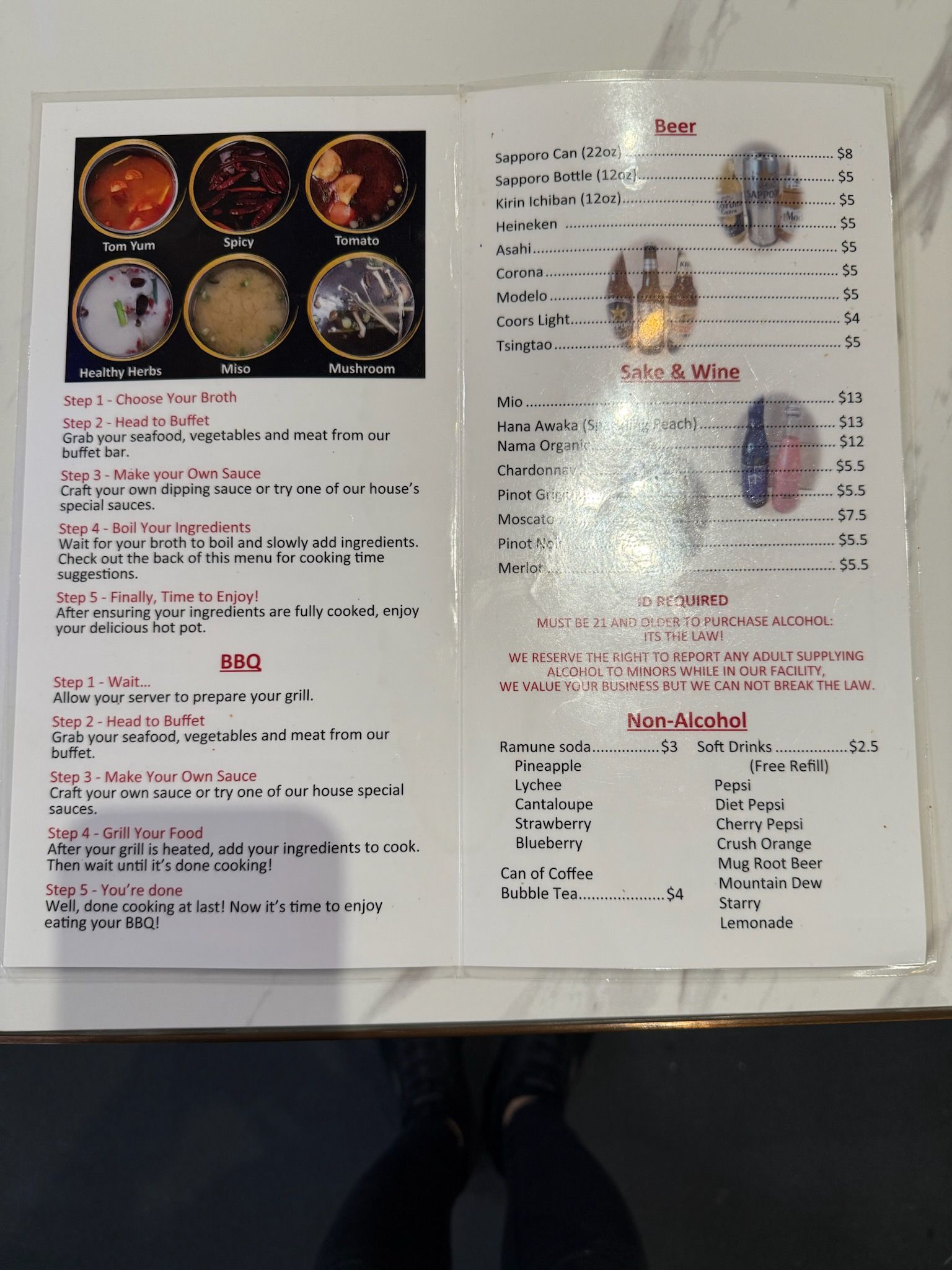 Open brochure with photos, Arabic text, and red headings on a light background.