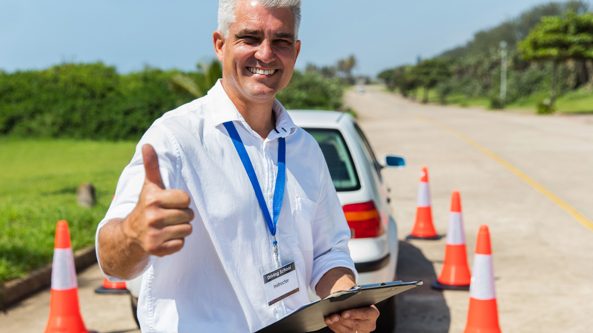 A man is giving a thumbs up while holding a clipboard.