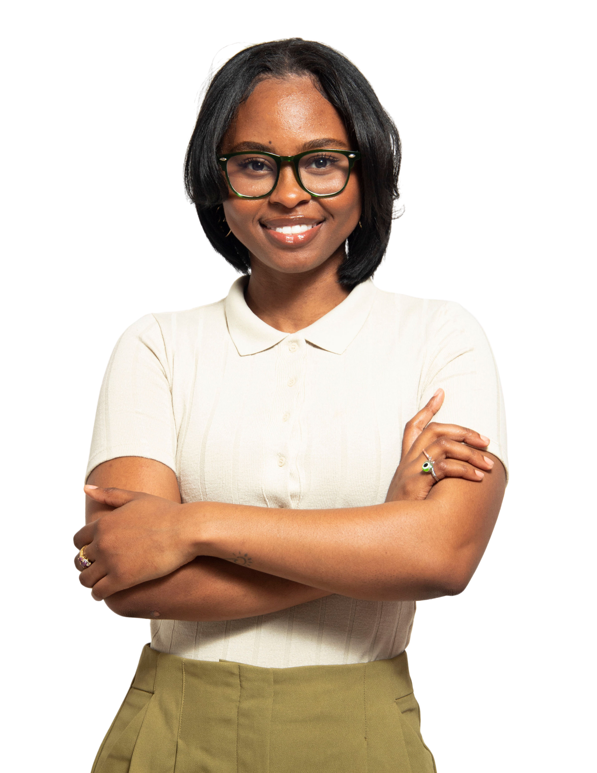 A woman wearing glasses and a white shirt is standing with her arms crossed.