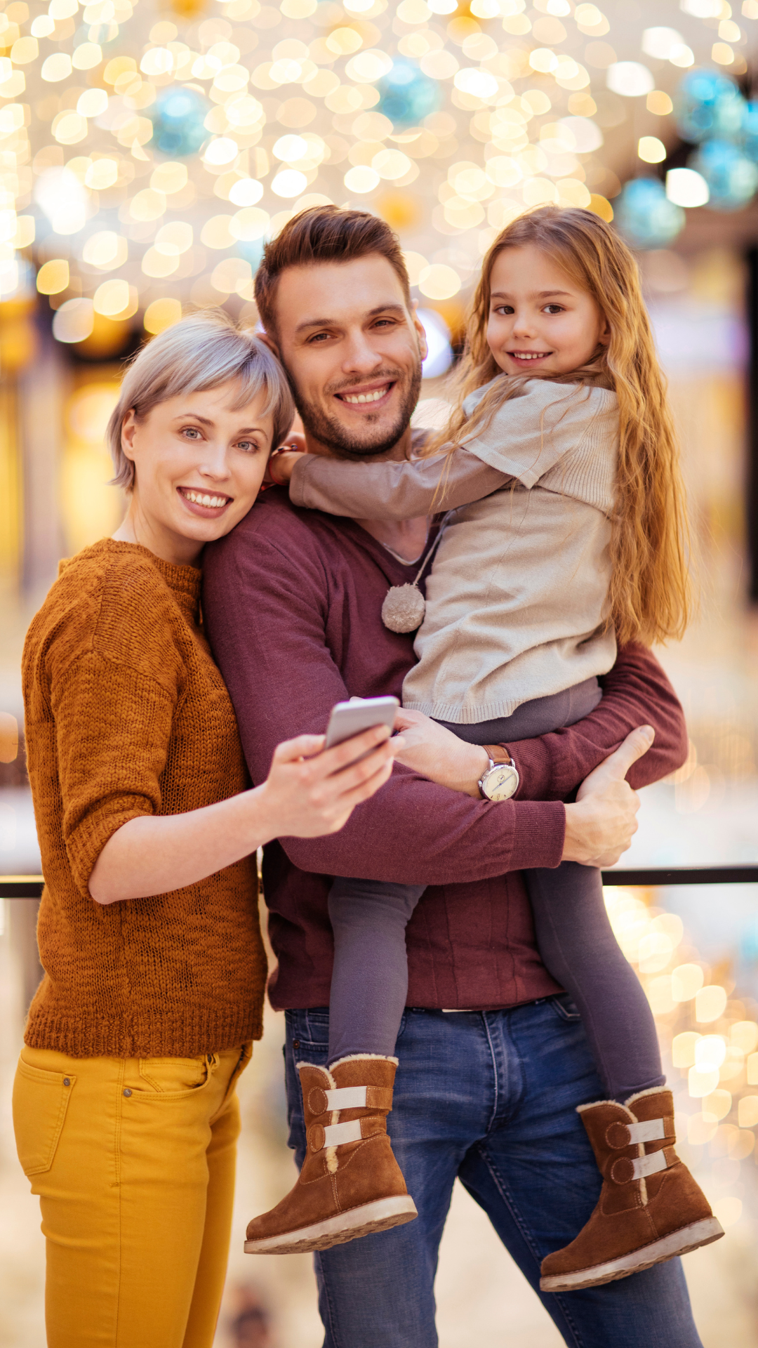 A family is posing for a picture in a shopping mall.