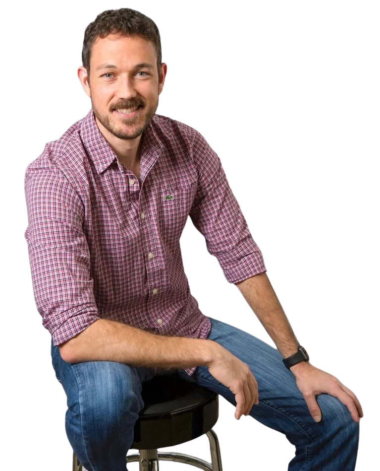 A man in a plaid shirt is sitting on a bar stool