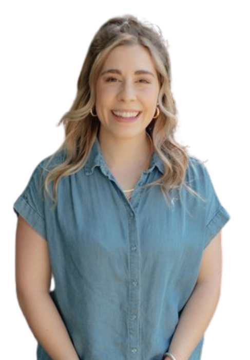 A woman in a blue shirt is smiling for the camera.