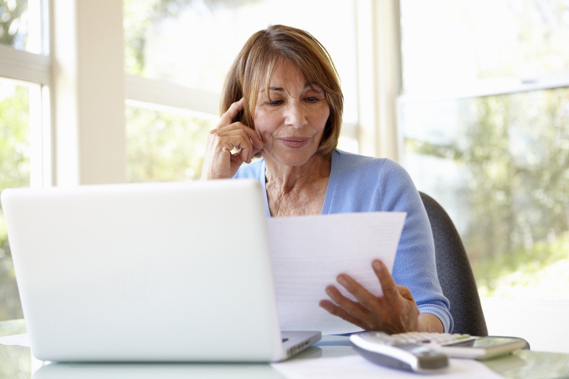 mature-woman-looks-at-paperwork