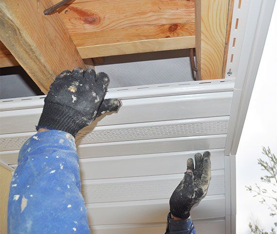 Worker Installing Soffit Boards — Springfield, MO — Diamond Exteriors