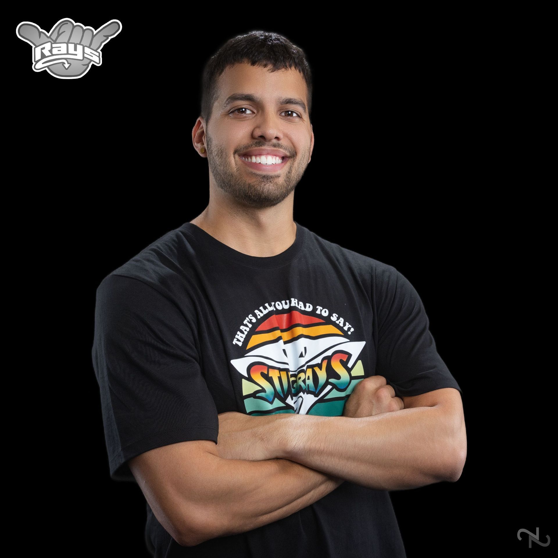 A man wearing a black shirt with the word sharks on it