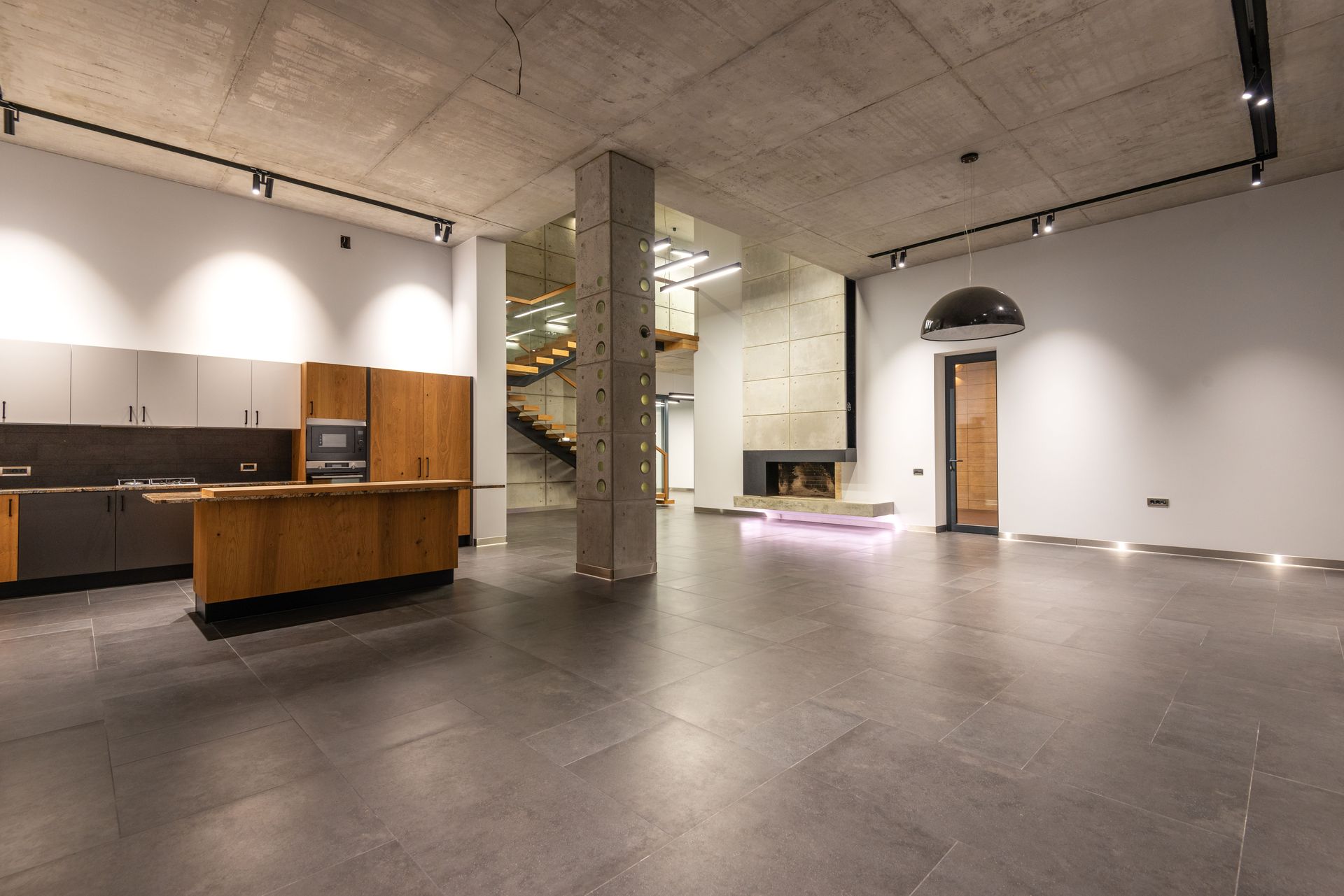 Spacious finished basement with polished floors, modern lighting, and waterproofing and sealing in Renton, WA.