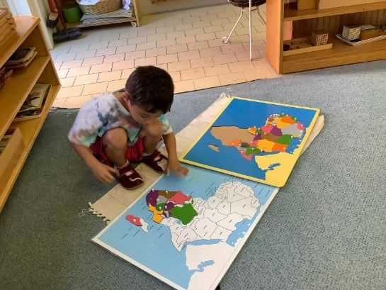 Adult reading a picture book with a child, encouraging curiosity through shared reading.