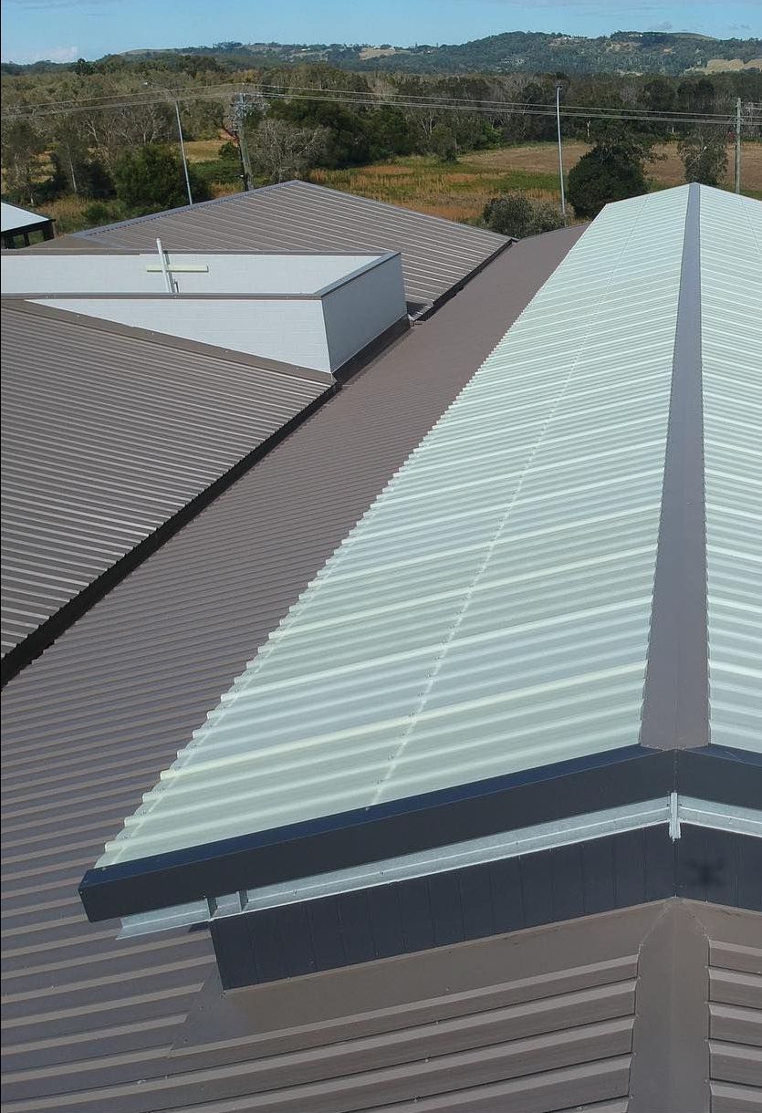 Building 's Roof With Trees in the Background — Northern Rivers Metal Roofing PTY LTD In Alstonville, NSW