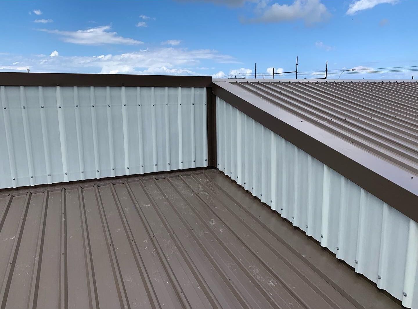 A Brown and White Metal Roof With a Blue Sky in the Background — Northern Rivers Metal Roofing PTY LTD In Ballina, NSW