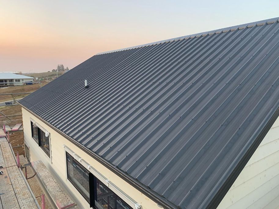 A House With a Black Metal Roof is Being Built — Northern Rivers Metal Roofing PTY LTD In Ballina, NSW