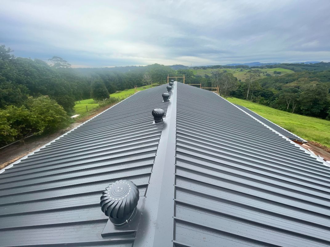The Roof of a Building With a View of a Field and Trees — Northern Rivers Metal Roofing PTY LTD In Ewingsdale, NSW
