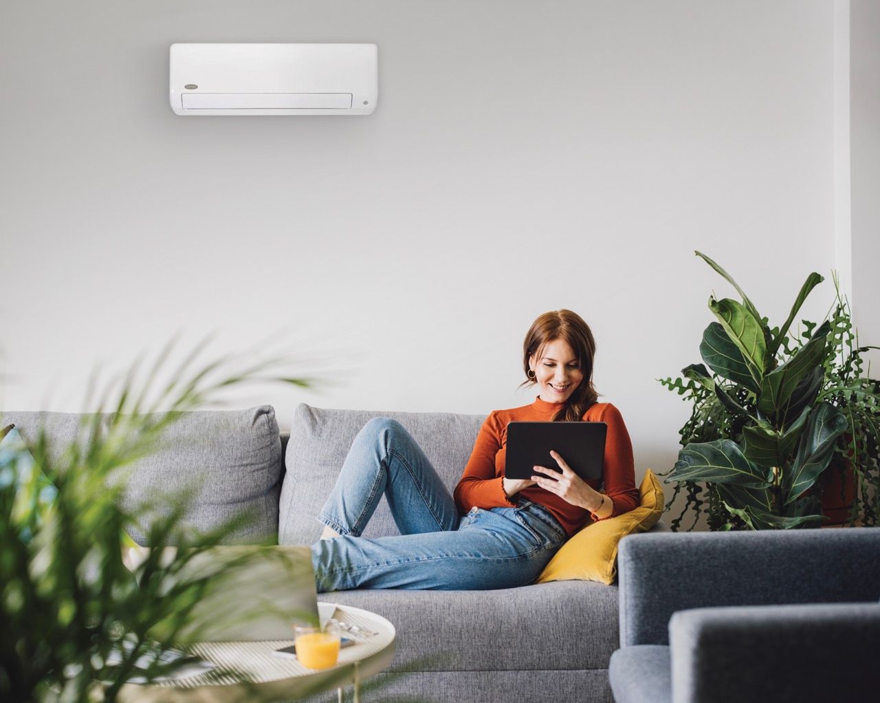 a person is cleaning a filter on an air conditioner .