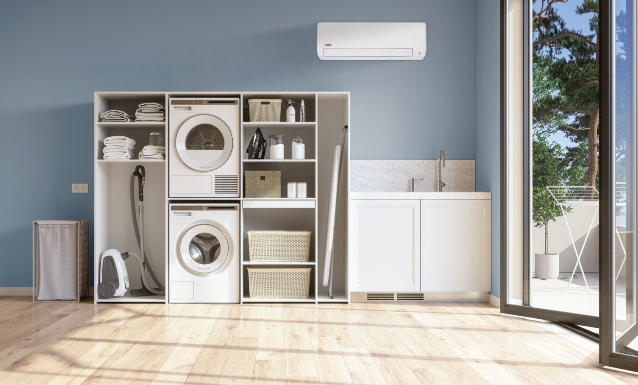 a square air conditioner is mounted to the ceiling in a room .