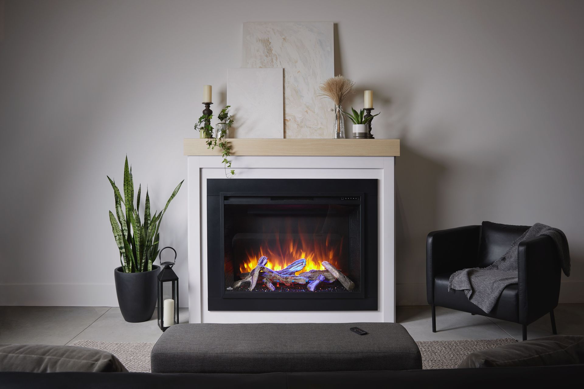 a living room with a fireplace , couch , chair and coffee table .