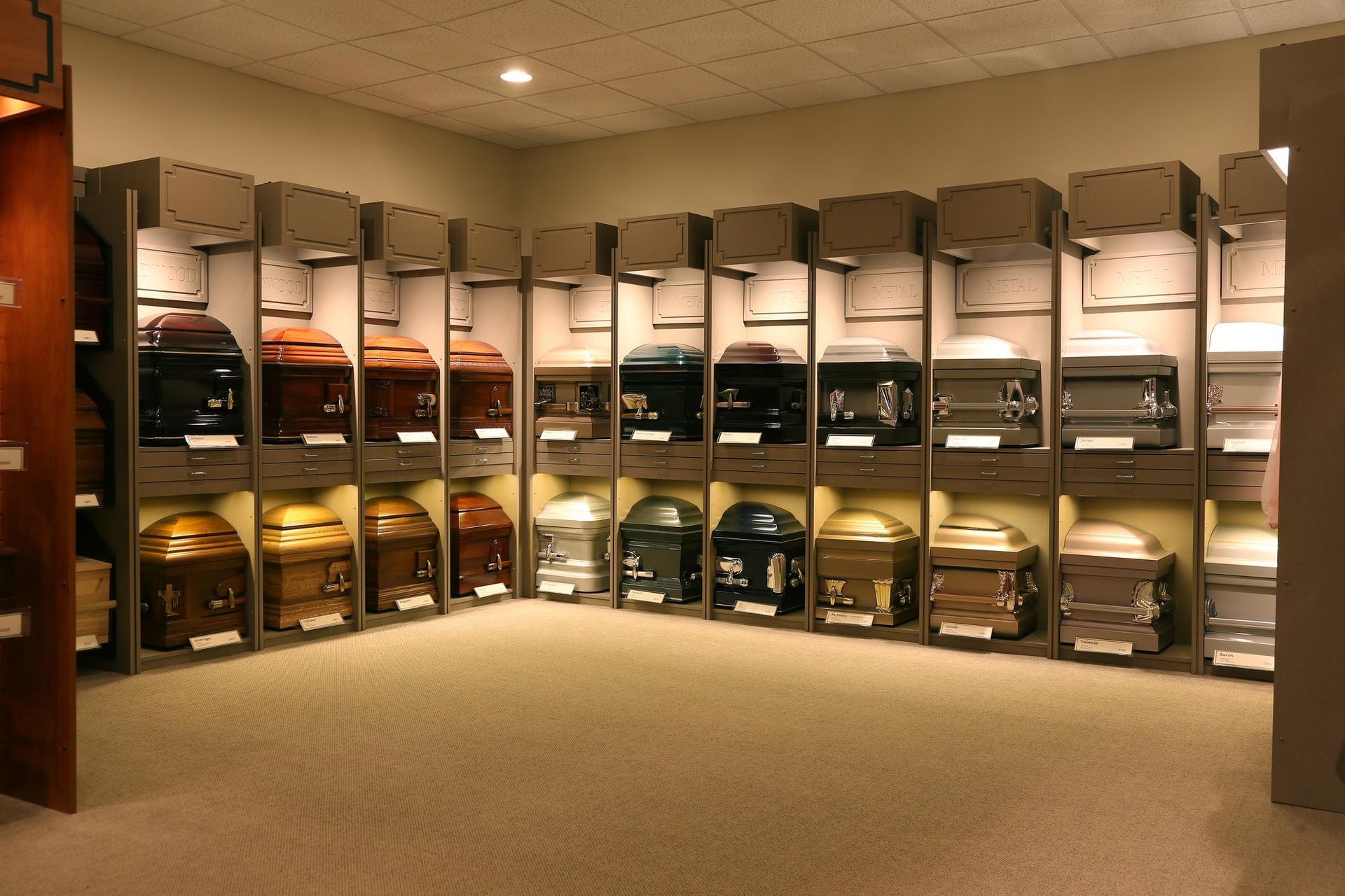 Locker room with rows of open lockers and folded clothing on shelves under warm lighting