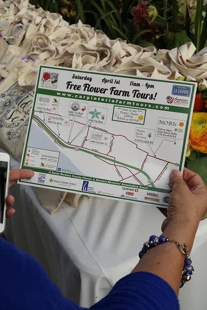 Hands holding a free tour farm tour map with routes and locations printed on it