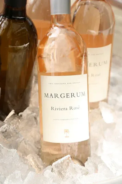 Bottle of Margerum River Road white wine chilling in ice with other wine bottles nearby