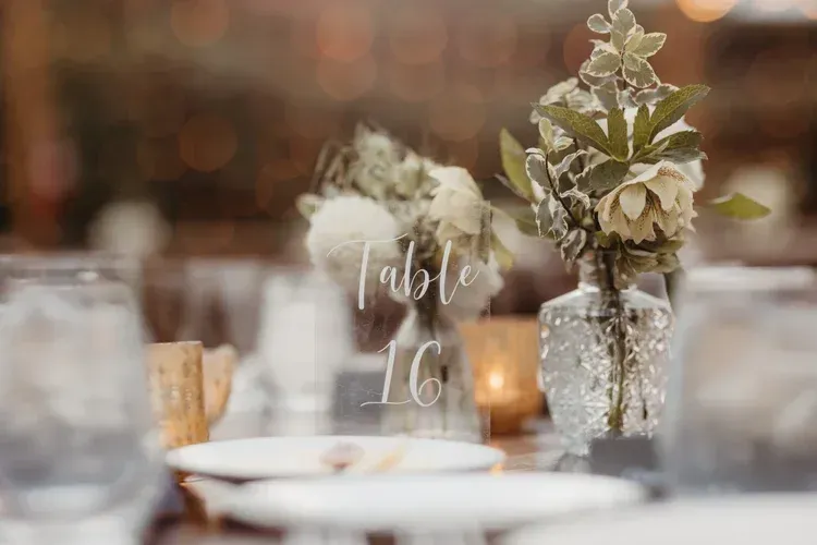 Table number 16 on a decorated wedding reception table with flowers and candlelight