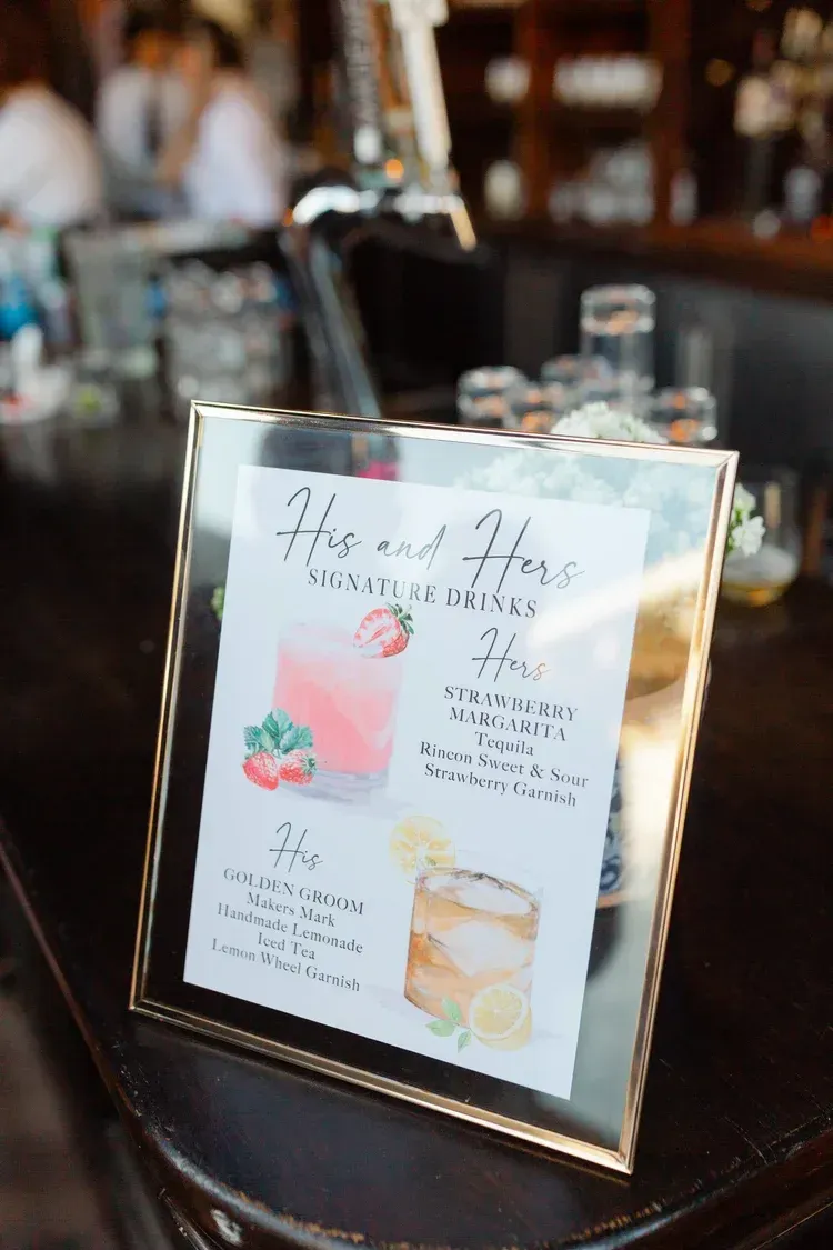 Framed menu sign on a table in a dimly lit restaurant or bar