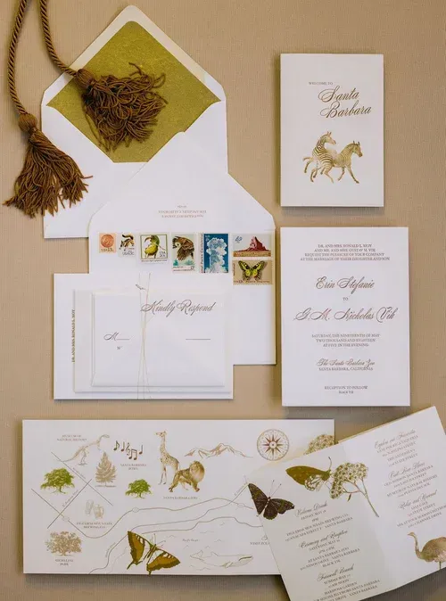 Elegant botanical wedding stationery suite in cream, gold, and green with butterflies, leaves, and invitation cards